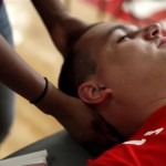 Zach Blair, Marine Corps team member, gets a massage before a wheelchair basketball game at the 2013 Warrior Games in Colorado Springs, Colo., May 12, 2013. Jeanette Falu-Bishop, the founder and executive director of Structure for Wounded Warriors, has offered body work to all competitors at the games. U.S. Marine Corps photo by Sgt. Justin Boling  